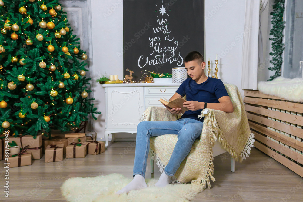 Man reads the book in the Christmas room photo