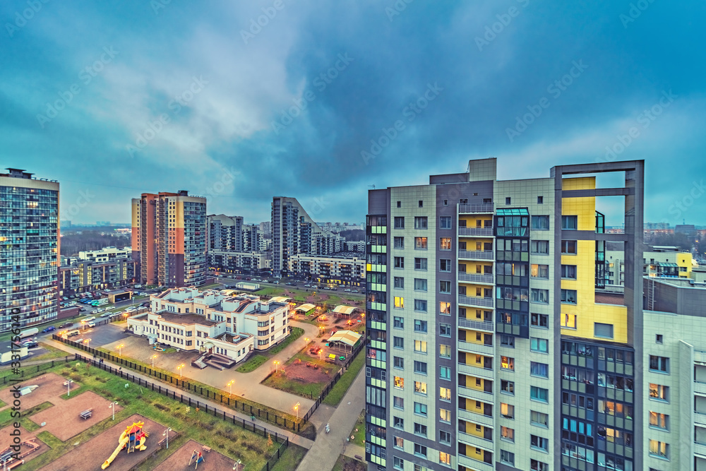 Obraz premium New modern residential buildings with lit windows