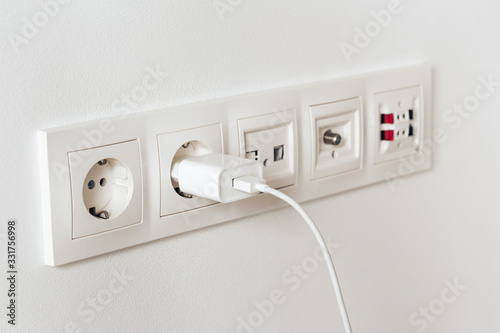 Sockets for electrical appliances on a white wall