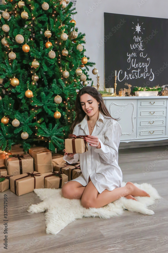 happy girl opening Christmas presents at home photo happy girl opening Christmas presents at home photo