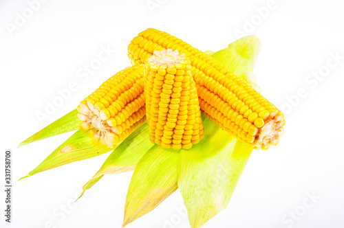 Ripe corn on the cob on a white background photo