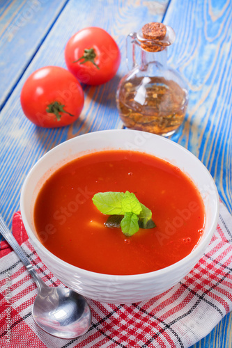 Tomato soup on wooden table.