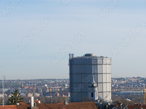 Die evangelische Kirche im Stadtteil Gaisburg vor dem Industriedenkmal Gaskessel in Stuttgart-Ost photo