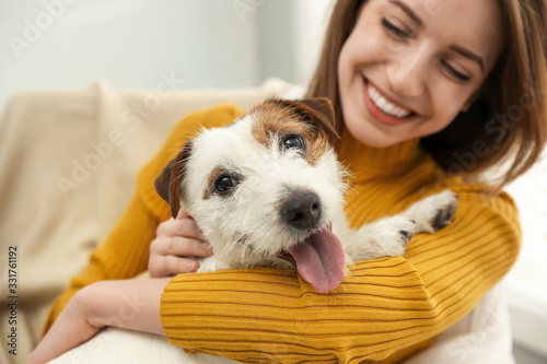 Fotografia, Obraz Young woman with her cute Jack Russell Terrier at home, closeup