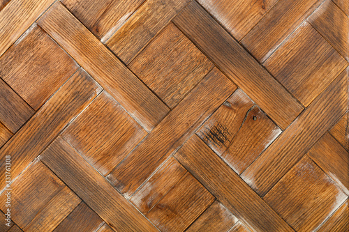 Rectangular old planks of transverse wooden planks are neatly laid out with a diamond pattern.