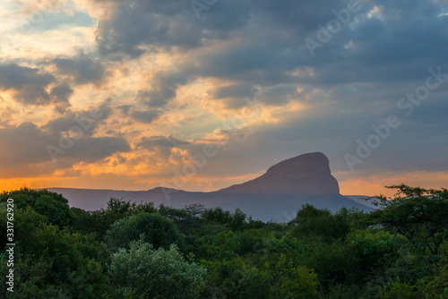 The Hanglip or Hanging Lip mountain peak towering above the african savannah at sunset  Entabeni Game Reserve  Limpopo Province  South Africa.