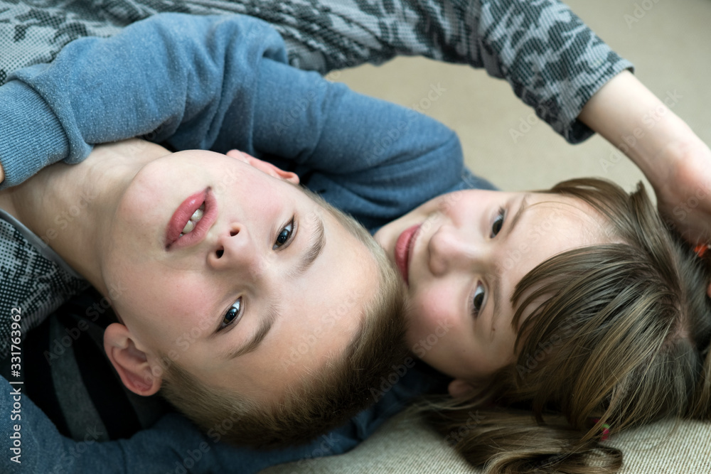Two children boy and girl fooling around having fun together. Happy childhood concept. Two children boy and girl fooling around having fun together. Happy childhood concept.