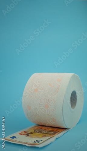 roll of toilet paper on sky blue background and levitating down, copy spece photo