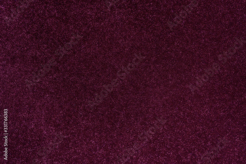 Dark magenta glitter twinkle abstract New Year or Christmas holiday background with sparkles. Modern luxury mock up with sequins. Texture of colored porous rubber with spangles