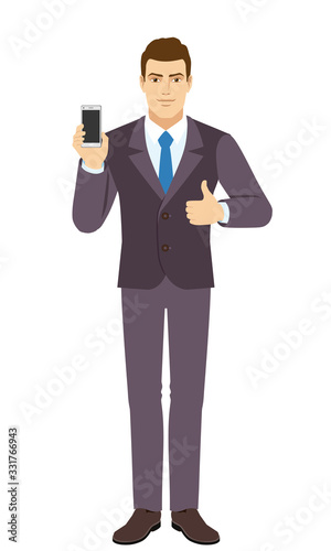 Smilig Businessman holding mobile phone and shows thumb up. Full length portrait of Businessman in a flat style.