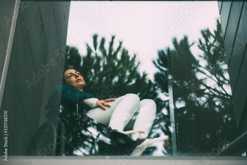 Photos Young disabled woman victim of a traffic accident looking out the window with a sad face