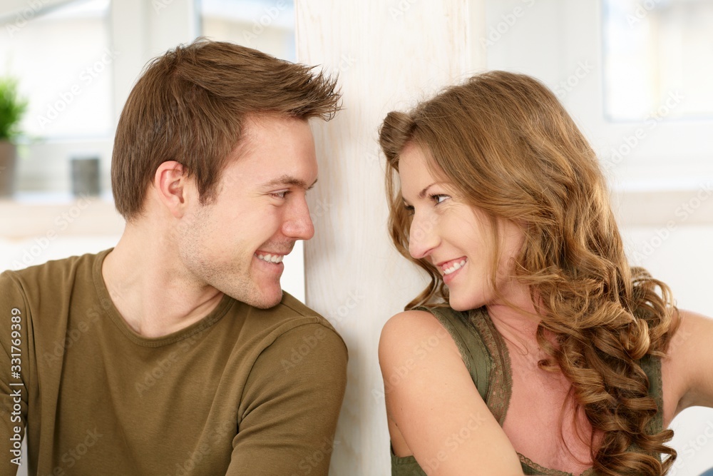 Happy couple looking at each other at home Happy couple looking at each other at home