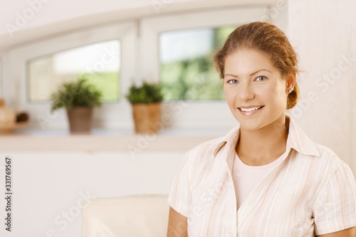 Free Download Portrait of happy young woman at home - GFXLoad
