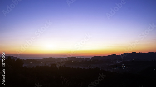 sunrise on horizontal line of mountain for waking