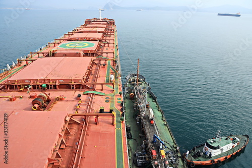 Bunkering of a ship on the open roadstead of the port of Nakhodka, Russia. photo