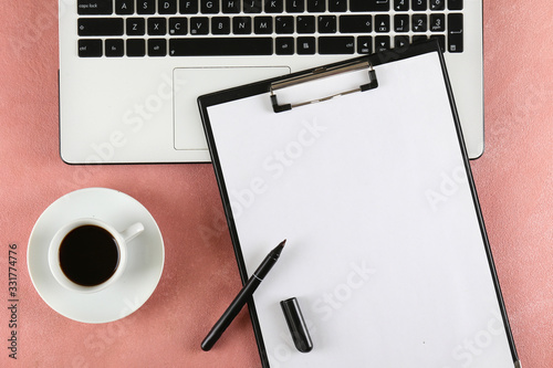 Cropped shot of black and white laptop keyboard with stationery accessories. Workspace of designer concept. Grunged stone background. Top view  flat lay  copy space.