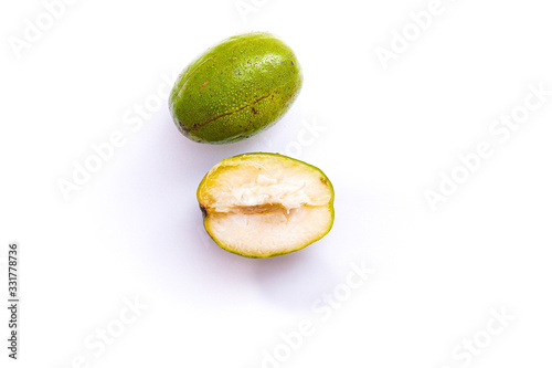 fresh green ambarella fruit that is still intact and that has been cut, isolated from a white background and copyspace, scientific name: Spondias dulcis