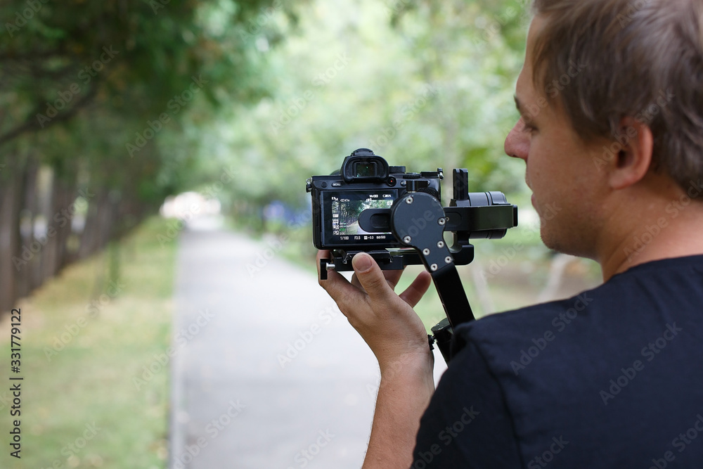 Photographer shooting a video outdoors Photographer shooting a video outdoors