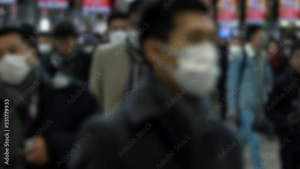 Slow motion Blurred defocused concept of coronavirus quarantine, MERS-Cov. Large crowd of business people with medical face mask. Air pollution. Virus has caused emergency situation.-Dan Slow motion Blurred defocused concept of coronavirus quarantine, MERS-Cov. Large crowd of business people with medical face mask. Air pollution. Virus has caused emergency situation.-Dan