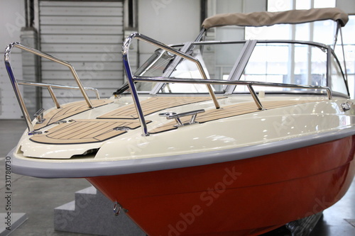 Принти на полотні Motor boat with white bow deck and orange bottom close up with brown marine teak