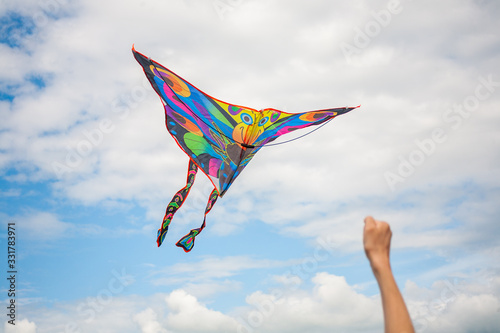 kite in hand against the blue sky in summer, flying kite launching, fun summer vacation, under the field, freedpm concept