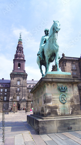 COPENHAGEN, DENMARK - JUL 06th, 2015: Christiansborg palace and King Christian IX statue. Famous landmark of danish capital. The seat of parliament on Slotsholmen