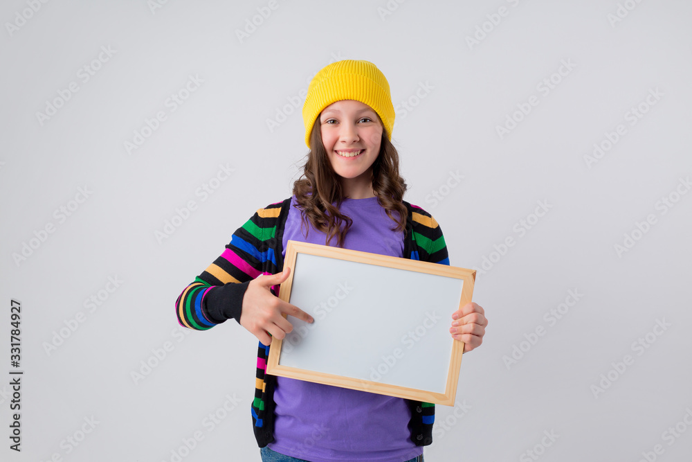 Teenage girl holds an empty drawing board, space for text Teenage girl holds an empty drawing board, space for text