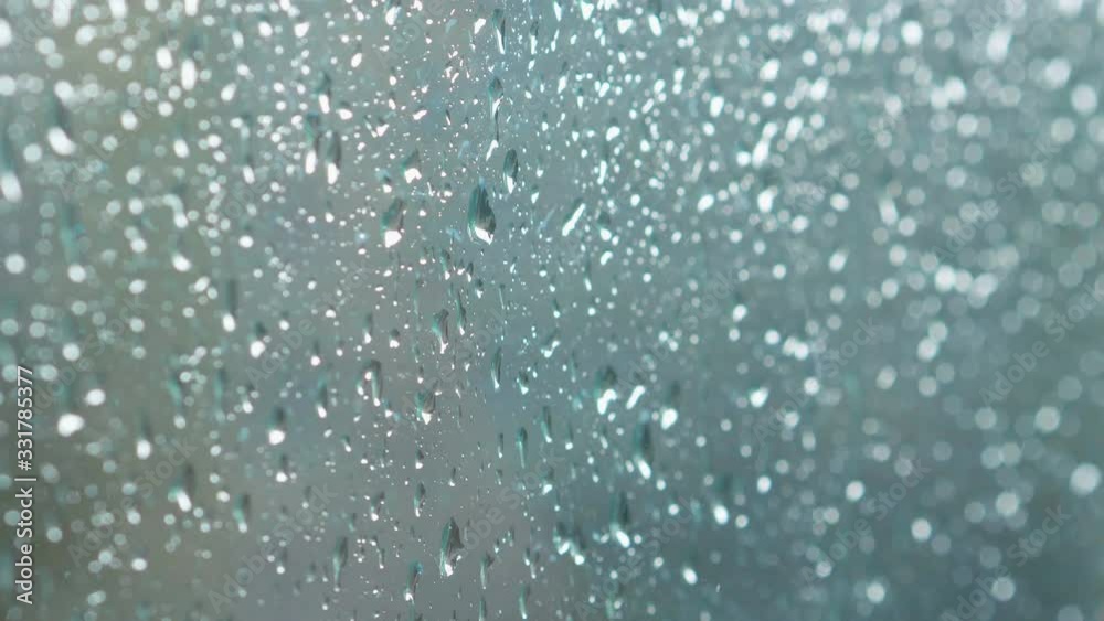 Wet glass window covered of water drops in 4K Slow motion 60fps Wet glass window covered of water drops in 4K Slow motion 60fps