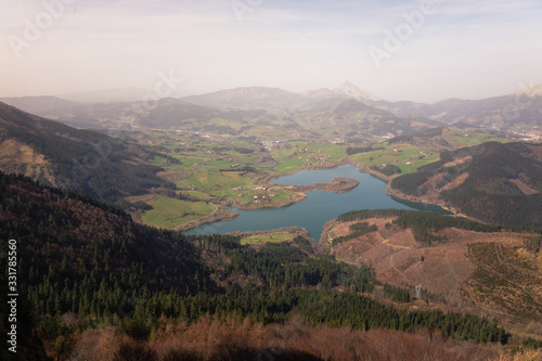 Urkulu reservoir surronded by mountains seen from the top of Orkatzategi hill, in Aretxabaleta, Basque Country. photo
