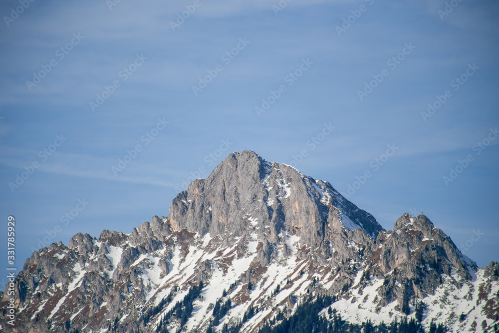 High alpine mountains with snow in Germany and blue beautiful sky