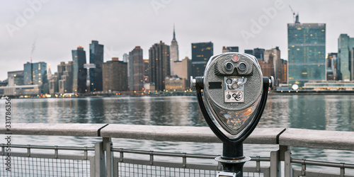 Panorama of tourist binoculars with Manhattan, New York City skyline in the background photo