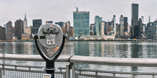 Panorama of tourist binoculars with Manhattan, New York City skyline in the background