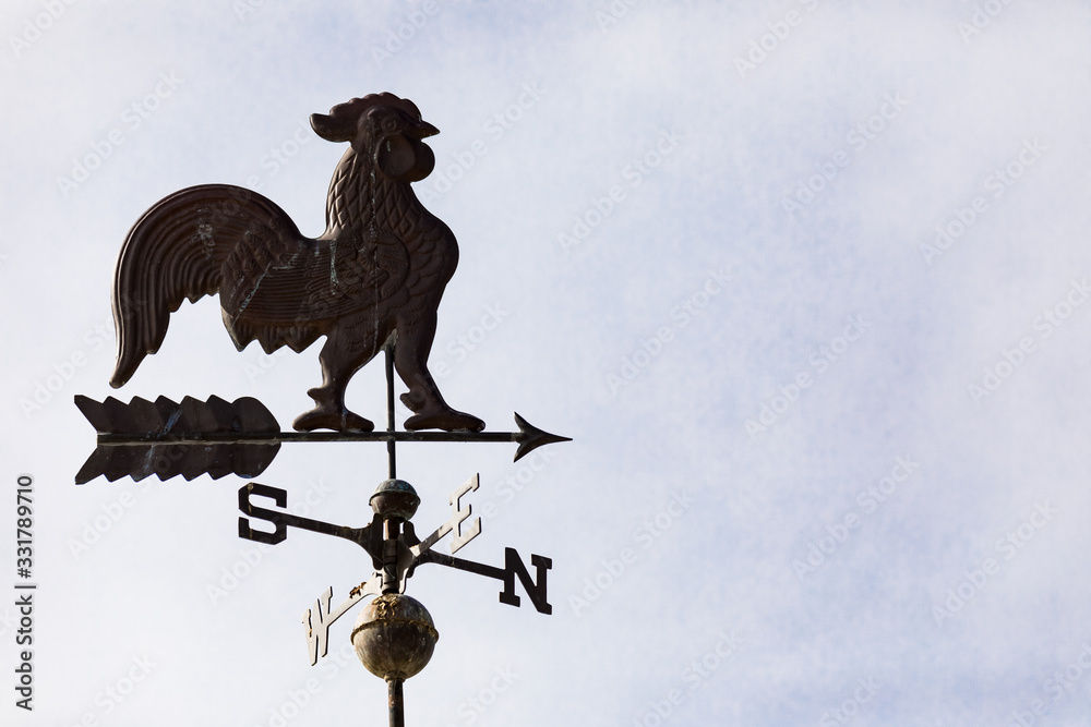 Weather vain with rooster and north, south, east, west directions Weather vain with rooster and north, south, east, west directions