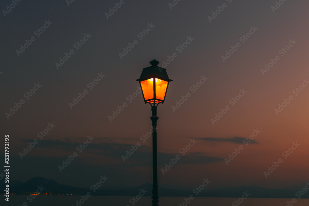 Evening sunset at the Greece. Lighting inside Lantern shining. Background picture.