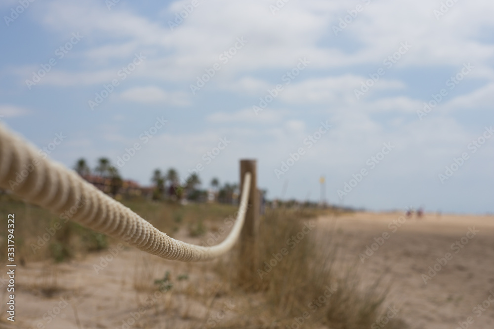 Fabric beige nautical rope on the beach