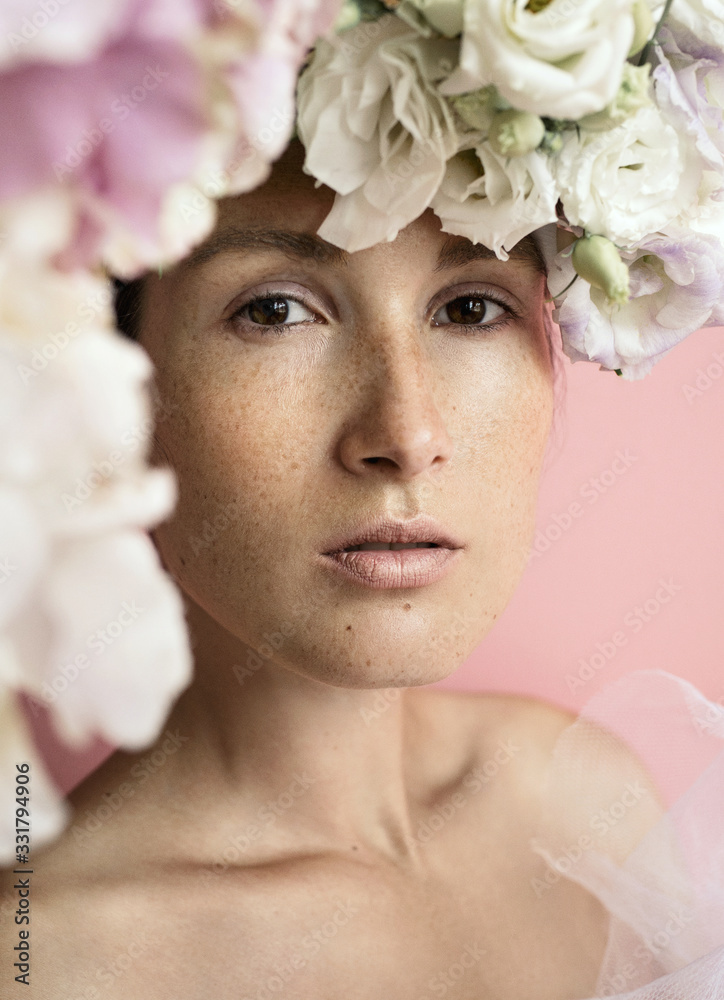 Gorgeous freckled young woman with eustoma flowers posing Gorgeous freckled young woman with eustoma flowers posing