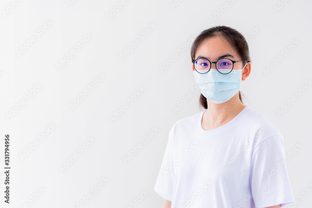 Studio portrait Asian young woman wears glasses and mask to protect against Coronavirus looking at camera, Thailand girl people on white background blank or copy space for anti virus Covid 19 concept Studio portrait Asian young woman wears glasses and mask to protect against Coronavirus looking at camera, Thailand girl people on white background blank or copy space for anti virus Covid 19 concept
