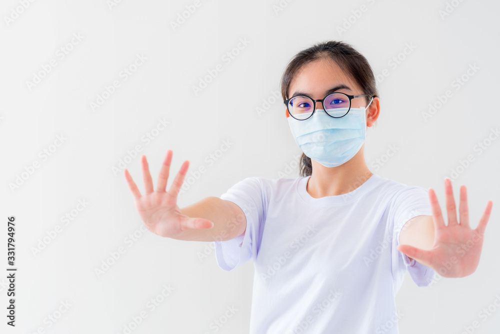 Portrait Asian young woman wears glasses and mask to protect against Coronavirus looking at camera, girl show hands stop coronavirus outbreak isolated on white background stop virus Covid 19 concept Portrait Asian young woman wears glasses and mask to protect against Coronavirus looking at camera, girl show hands stop coronavirus outbreak isolated on white background stop virus Covid 19 concept