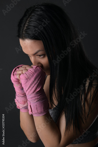Woman boxer training hard.