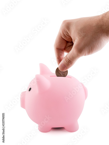 Pink piggy bank and hand with coin isolated on white