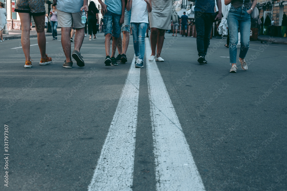 Two white lines on the road where people walking