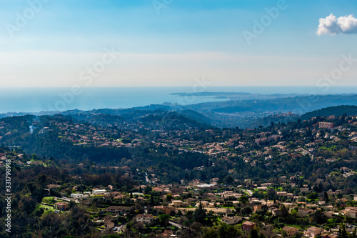 A close-up panoramic view of the old medieval French town Vence and other town s buildings with the low Alps mountains hills and the Mediterranean Sea on the horizon  Provence   Riviera   C  te d Azur 