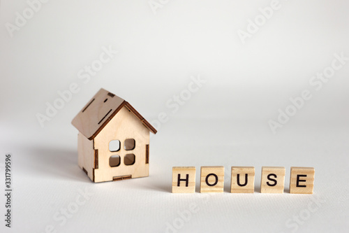 Wooden house model and wooden letters with the inscription House