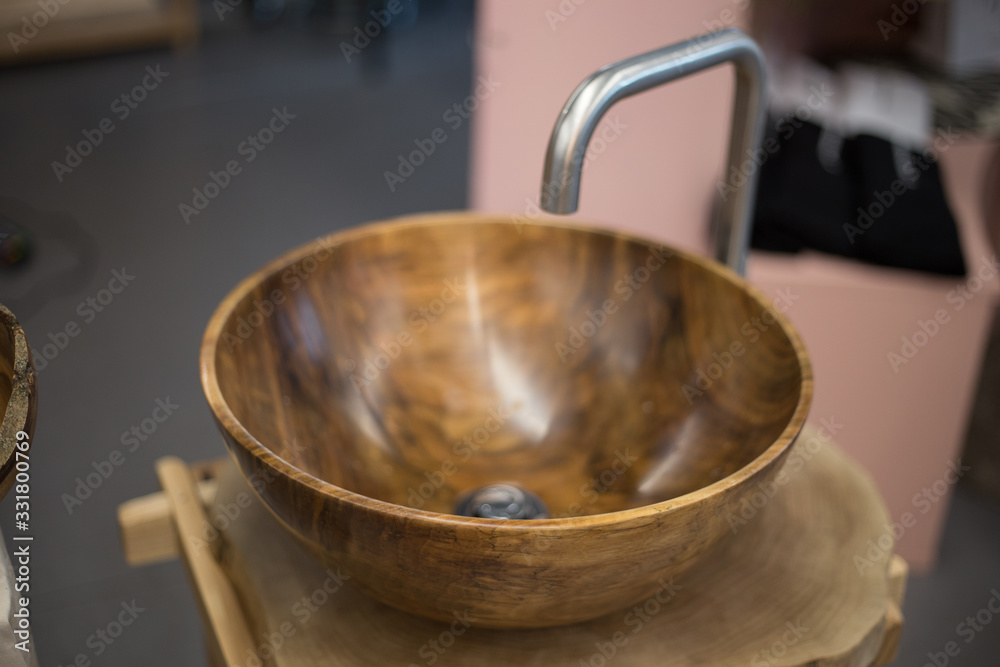 Wooden washbasin on a wooden stand in the bathroom