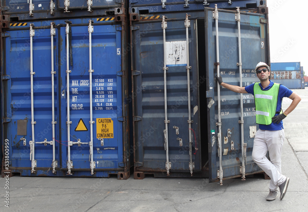 Worker inspecting cargo shipping containers. before departure.
