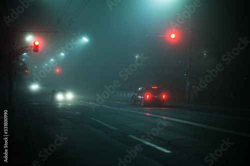 Highway road at night in the fog in the city