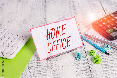 Handwriting text Home Office. Conceptual photo space designated in a demonstrating s is residence for official business Notepaper stand on buffer wire in between computer keyboard and math sheets photo