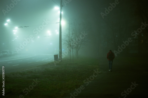 Fototapeta Naklejka Na Ścianę i Meble -  Lonely man at night in the fog in the city