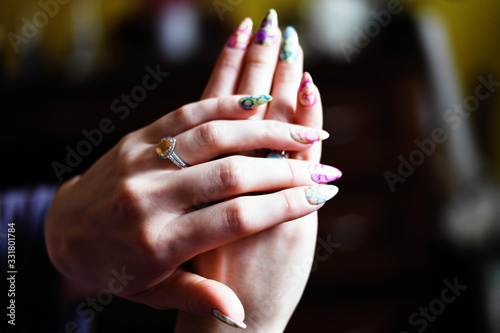 Woman hands held on top of each other  nice finger nail and a silver ring with citrine stone  watercolor and colorful style  white gold.