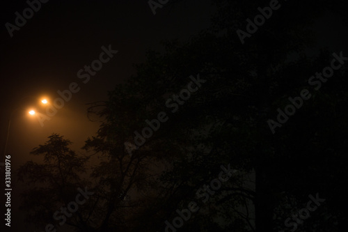 Lantern at night in the fog in the city